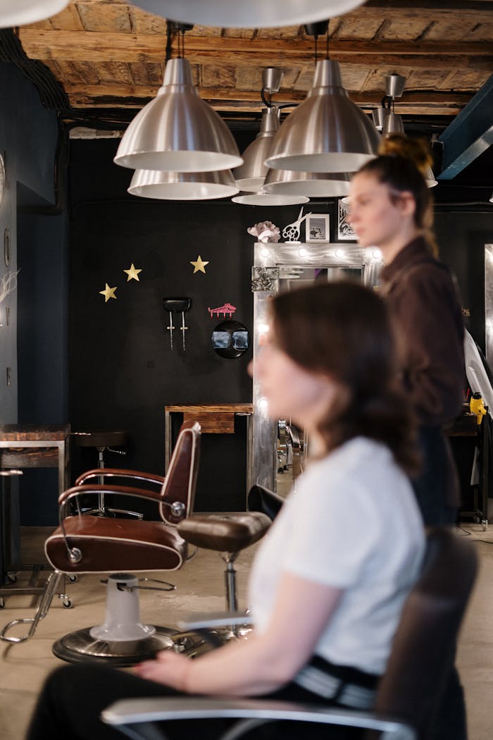 A hair stylist attends to a client in a modern and stylish salon interior.